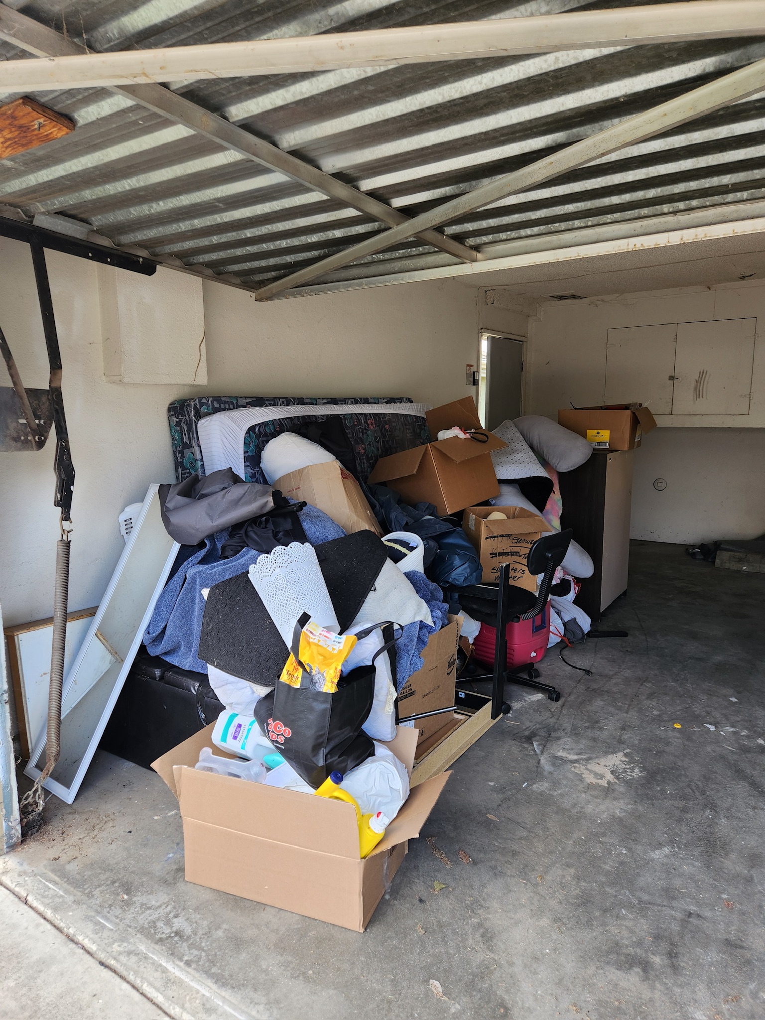 Cluttered garage before cleanout